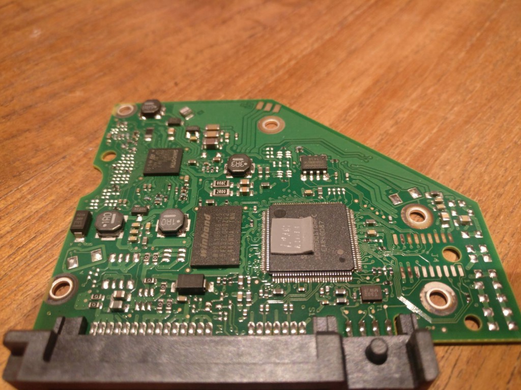PCB of a Seagate 2TB desktop drive. The SATA connector pins are visible on the bottom.